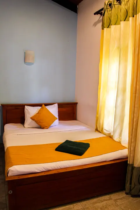 Compact room with a single bed and golden runner